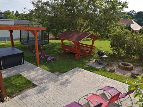 a backyard with a picnic table and chairs and a grill at Villa Pedro in Szigliget