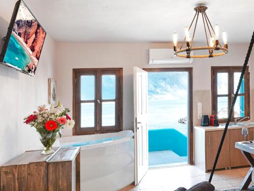 a kitchen with a view of the ocean at Secret Gem Suites in Oia