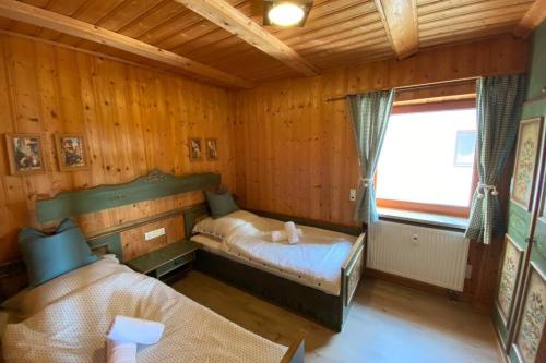 a small bedroom with a bed and a window at Mitten im Bayerischen Wald + Schönblick + Urig + NETFLIX in Schöfweg