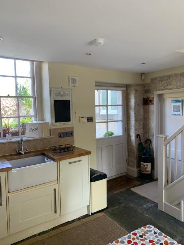 a kitchen with a sink and a microwave at Wee Grange in Bath