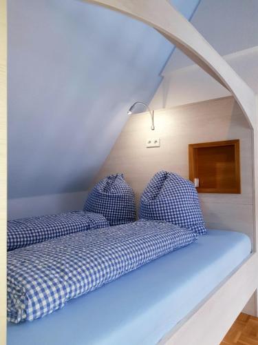 two blue pillows sitting on a bed in a room at Das Nachtwächterhäuschen in Tecklenburg