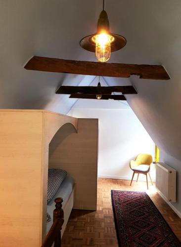 a bedroom with a bunk bed with a ceiling at Das Nachtwächterhäuschen in Tecklenburg