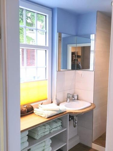 a bathroom with a sink and a mirror at Das Nachtwächterhäuschen in Tecklenburg