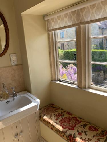 a bathroom with a sink and a window at Wee Grange in Bath
