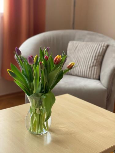a vase of flowers sitting on a table at CentROOM Nagykanizsa in Nagykanizsa