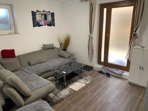 a living room with a couch and a table at Apartments Old Town Izola in Izola