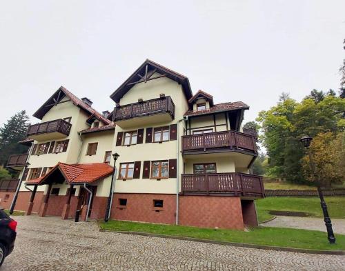 a large building with balconies on top of it at Apartament 4 osobowy, sauna, sala fitness in Szklarska Poręba