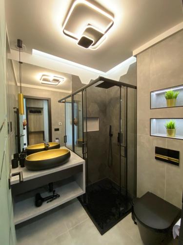 a bathroom with a large tub and a shower at Relax Sauna Apartman privát finn szaunával in Keszthely