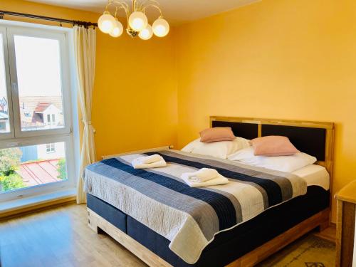 a bedroom with a bed with two towels on it at Hotel U Rytíře in Mělník