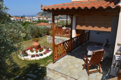 a patio with a garden with a flower arrangement at Remvi Apartments in Skopelos Town