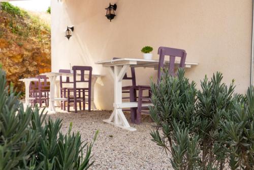 two chairs and a table and a table and chairs at Mare Casia Bozcaada Otel in Bozcaada