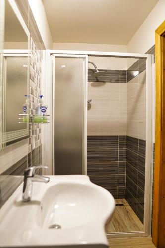 a bathroom with a sink and a shower at Chata Říp in Rokytnice nad Jizerou