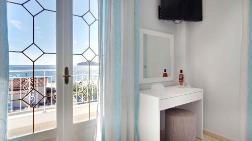 a room with a window with a view of the ocean at Azure Mare Studios in Corfu