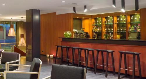 a bar with a row of stools in a restaurant at Astari in Tarragona