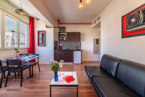a living room with a couch and a table at Ben Yehuda Apartments in Tel Aviv