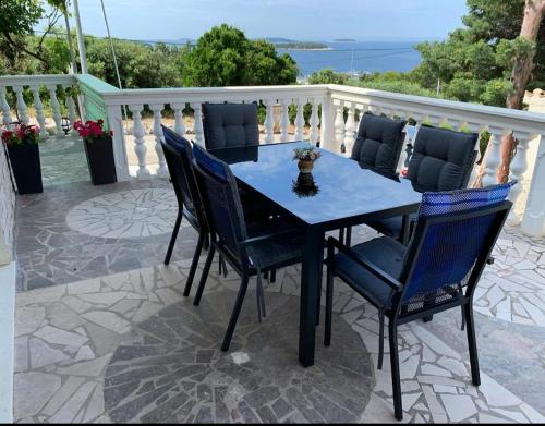a black table and chairs on a patio at Apartments Neda in Primošten