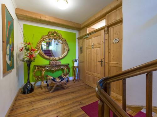 a hallway with a green wall and a mirror at VillaFrancesca - Emanuela/Raffaela in Zell am Ziller