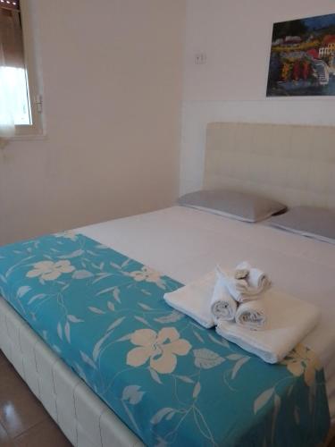 a bed with towels sitting on top of it at Camera Noemi in Torre Lapillo