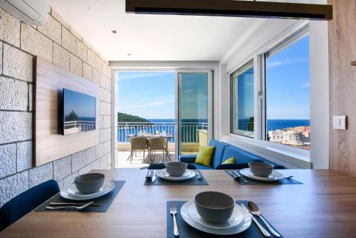 a dining room with a table and a view of the ocean at Villa Leoni in Dubrovnik