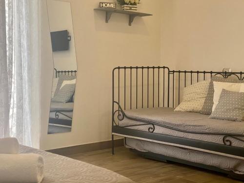a bedroom with a iron bed and a mirror at B&B Central Station Suite in Naples