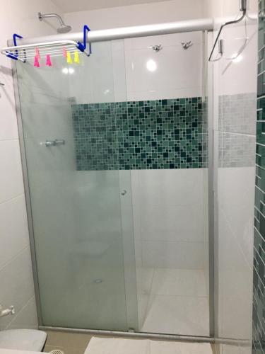 a shower with a glass door in a bathroom at Praia dos Carneiros apart beira-mar in Tamandaré