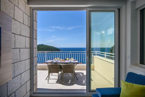 a balcony with a table with a view of the ocean at Villa Leoni in Dubrovnik