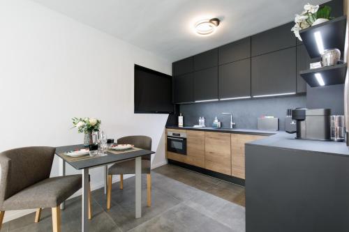 a kitchen with a table and chairs in a kitchen at Cannes CROISETTE, Palais des Festivals, Beaches, Apart Residence Le MINERVE in Cannes