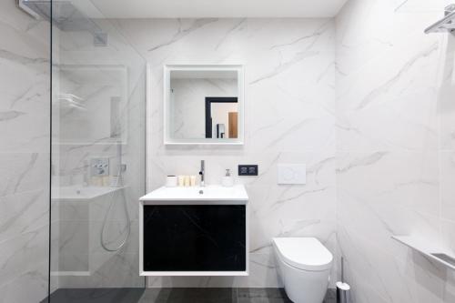 a white bathroom with a sink and a toilet at Cannes CROISETTE, Palais des Festivals, Beaches, Apart Residence Le MINERVE in Cannes