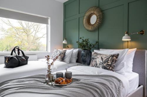 a bedroom with two beds and a large window at Large Luxury Solihull 5 Bedroom House - The Residence - Close to NEC - Sleeps 9 in Solihull