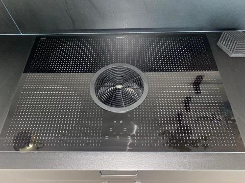a metal fan in the middle of a microwave oven at Lovely apr with sauna at the best area of Oulu in Oulu