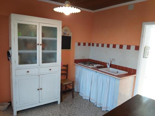 a kitchen with a white cabinet and a sink at la punta dei crociati in Parodi Ligure