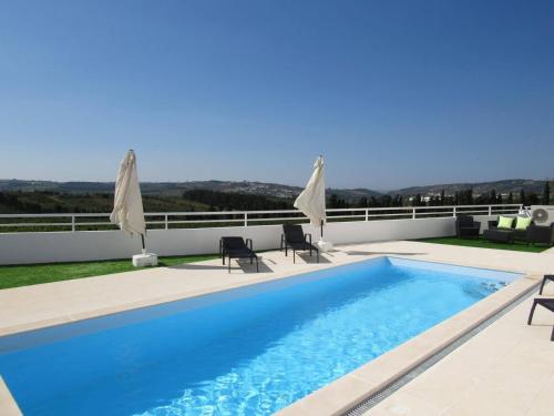 a swimming pool on the roof of a house at Casa da Colina - Villa in the Countryside in Sobral do Parelhão
