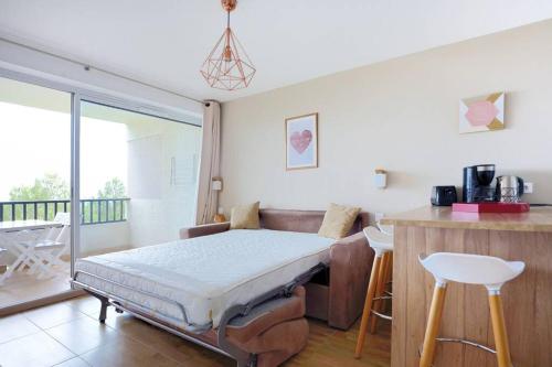 a bedroom with a bed and a balcony at Vu Mer by K6&You in Cassis