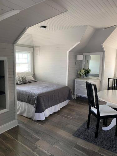 a bedroom with a bed and a table and a chair at Ocean Manor 1100 Inn in Ocean City