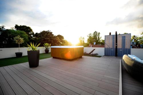 a deck with a hot tub in the middle of a backyard at Feel Good Penthouse With Jacuzzi in Zadar