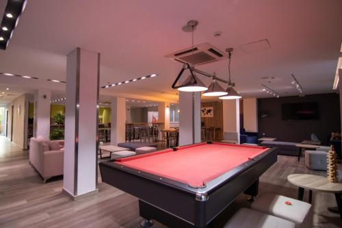 a pool table in the middle of a room at Athens Hawks in Athens