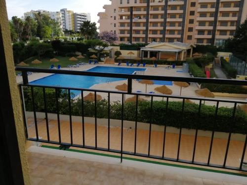 a view of a swimming pool from a balcony at Club Amarílis,Alex&Mila Aparthotel Praia da Rocha in Portimão