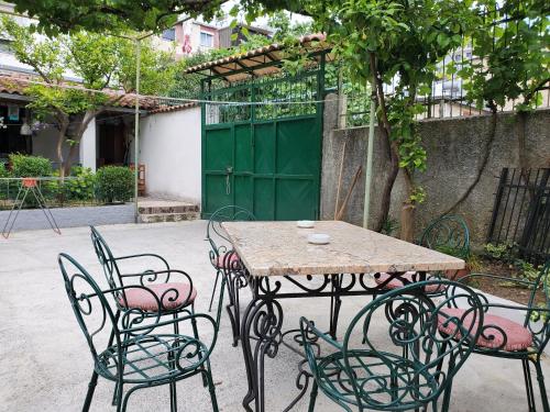 a wooden table and chairs in a courtyard at Unique Traditional House, hosted by J&G in Tirana