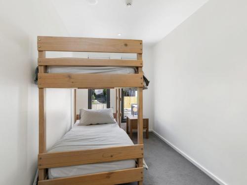 a bedroom with two bunk beds in a room at One 36 in Lorne