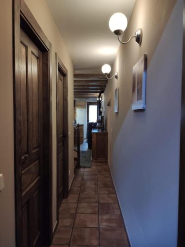a hallway with a door and a tile floor at LAS 4 ESTACIONES - Rascafría in Rascafría