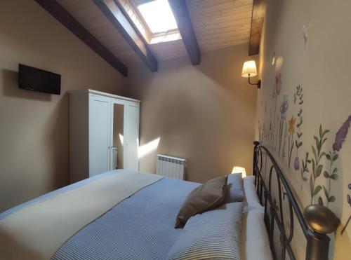a bedroom with a bed and a skylight at LAS 4 ESTACIONES - Rascafría in Rascafría
