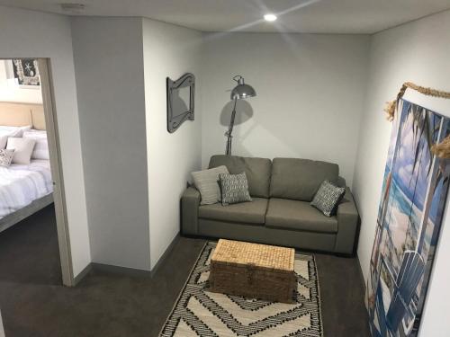 a living room with a couch and a bed at Ocean Breeze Apartment Portland in Portland
