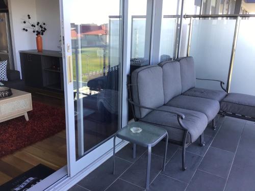 a living room with a couch and a table at Ocean Breeze Apartment Portland in Portland