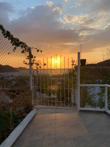 a sunset seen through a gate on a patio at Vito Hotel Boutique Taganga in Taganga