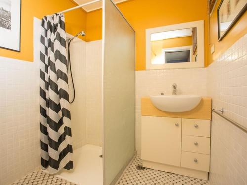 a small bathroom with a sink and a shower at Banksia Seven in Merimbula