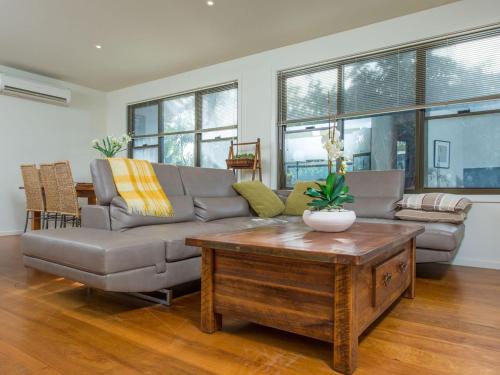 a living room with a couch and a coffee table at Rolling Waves No 2 in Merimbula