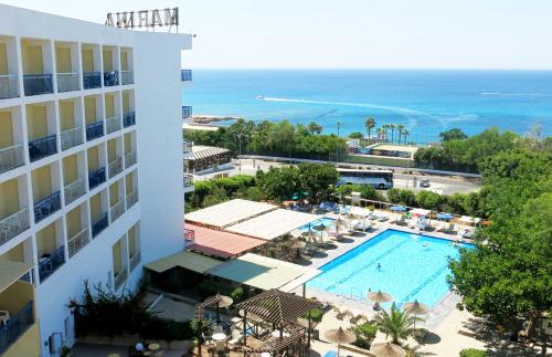 a view of the pool and ocean from the balcony of a hotel at Marina Hotel in Ayia Napa