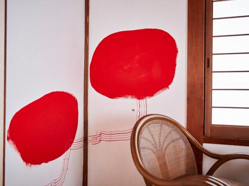 a wall with three red balls on it at Kikusui Ryokan in Tamano