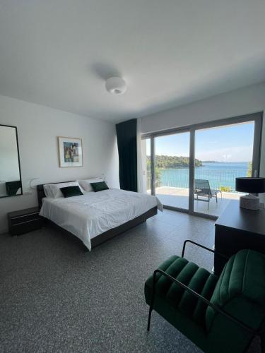 a bedroom with a bed and a view of the ocean at Buric House - M suite - 95m2 and 54 m2 terrace in Rovinj