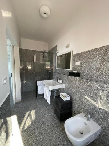 a bathroom with a sink and a toilet and a tub at Buric House - M suite - 95m2 and 54 m2 terrace in Rovinj